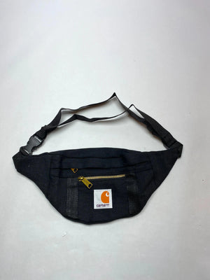 Black with gold-tone zippers and Carhartt logo patch