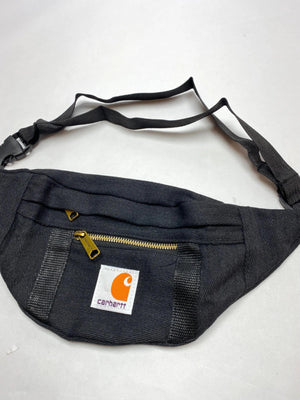 Black with gold-tone zippers and Carhartt logo patch