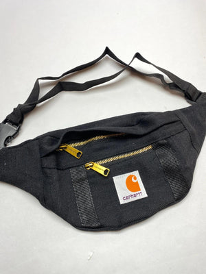 Black with gold-tone zippers and Carhartt logo patch